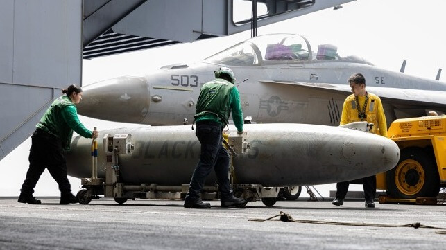 Crew of the carrier USS Gerald R. Ford move a drop tank on deck, Red Sea, April 19 (Central Command)